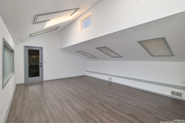 bonus room featuring dark hardwood / wood-style flooring and vaulted ceiling