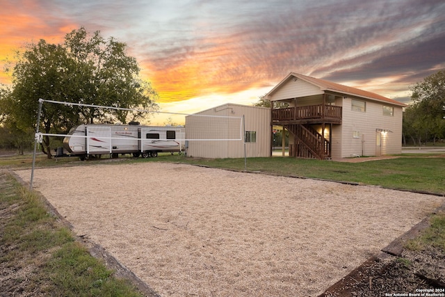 exterior space with a storage unit, a yard, and a wooden deck