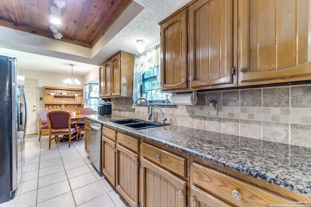 15618 Elks Pass St, San Antonio, TX 78232 - kitchen with a sink, stainless steel appliances, tasteful backsplash, brown cabinets, and light tile patterned floors