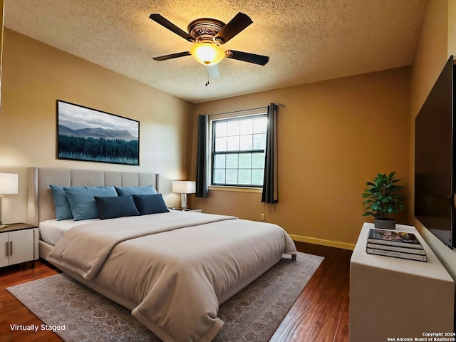 15618 Elks Pass St, San Antonio, TX 78232 - bedroom with a textured ceiling, dark wood-type flooring, baseboards, and ceiling fan
