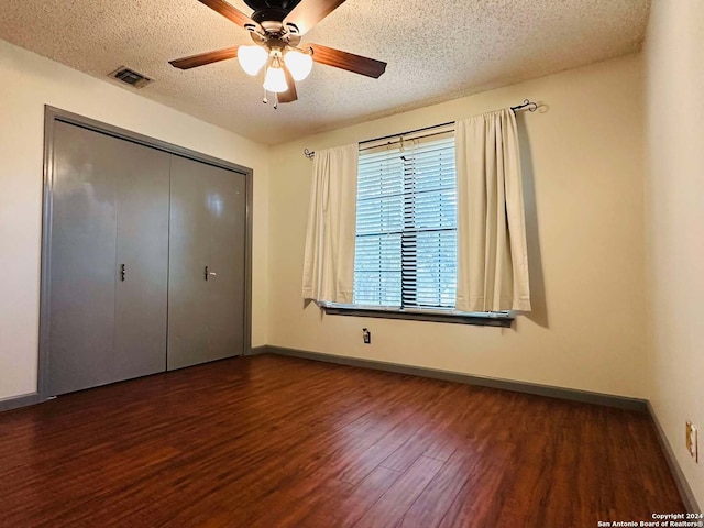 15618 Elks Pass St, San Antonio, TX 78232 - unfurnished bedroom featuring wood finished floors, a textured ceiling, a closet, baseboards, and a ceiling fan