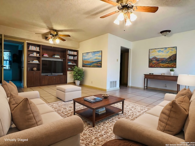 15618 Elks Pass St, San Antonio, TX 78232 - living area with a ceiling fan, light tile patterned flooring, baseboards, and a textured ceiling