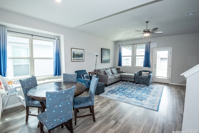 dining area with hardwood / wood-style floors and ceiling fan