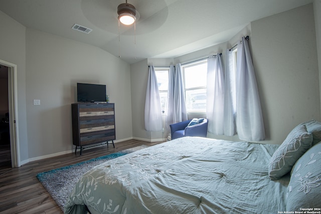 bedroom featuring ceiling fan, dark wood-type flooring, and lofted ceiling