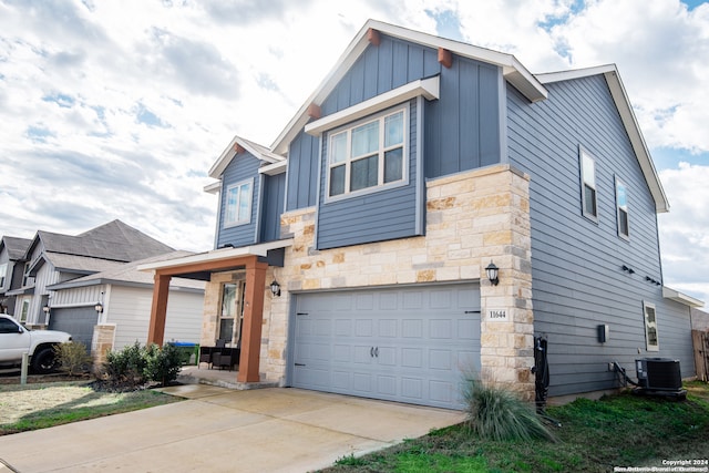 view of front of home featuring a garage and central air condition unit