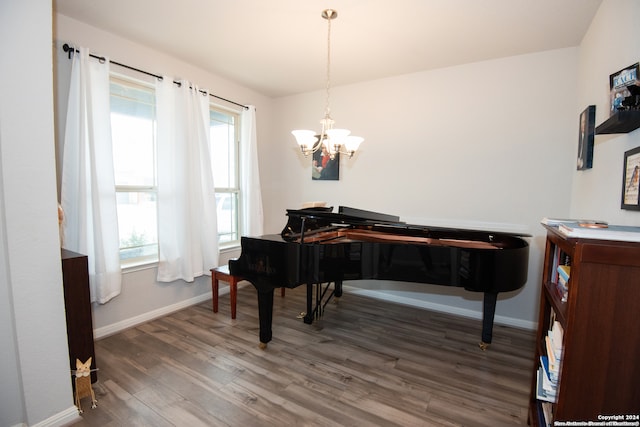 miscellaneous room with plenty of natural light, dark wood-type flooring, and a notable chandelier