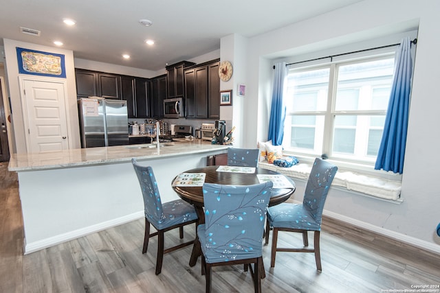 dining room featuring light hardwood / wood-style flooring and sink