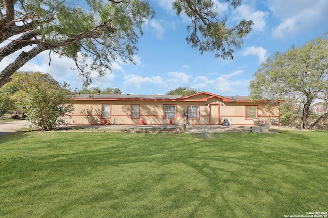 rear view of property with a yard