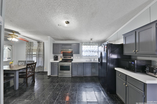 kitchen featuring gray cabinets, stainless steel gas range oven, and a textured ceiling