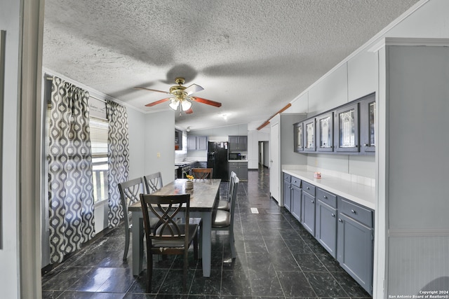 dining space with a textured ceiling, crown molding, ceiling fan, and lofted ceiling