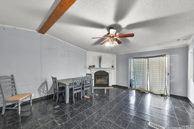 dining room featuring ceiling fan, a textured ceiling, and ornamental molding