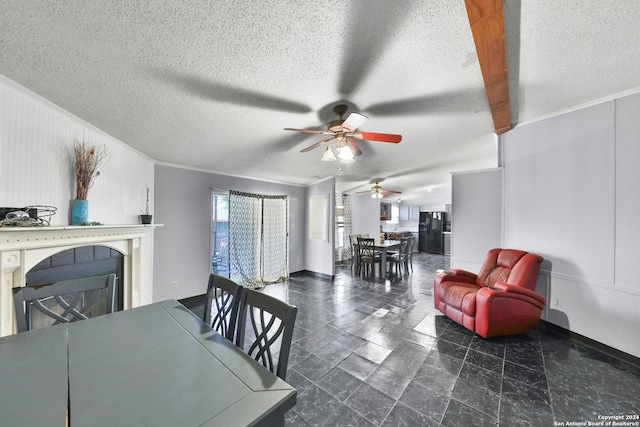 dining room featuring a textured ceiling, ceiling fan, and ornamental molding