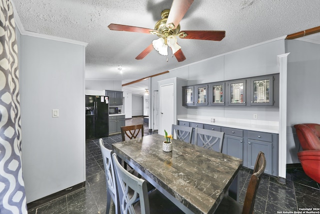 dining space featuring ceiling fan, a textured ceiling, and ornamental molding