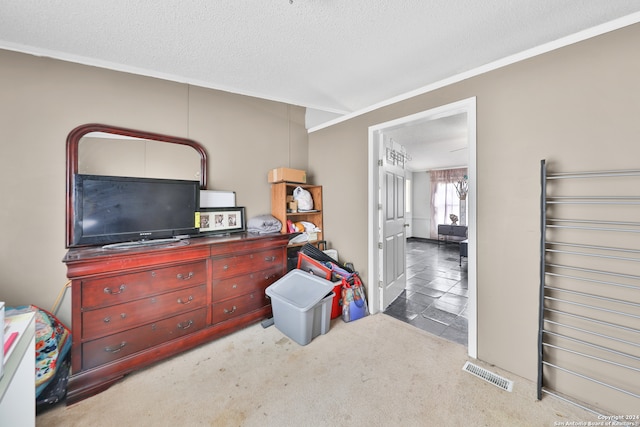 miscellaneous room with a textured ceiling, light colored carpet, and crown molding