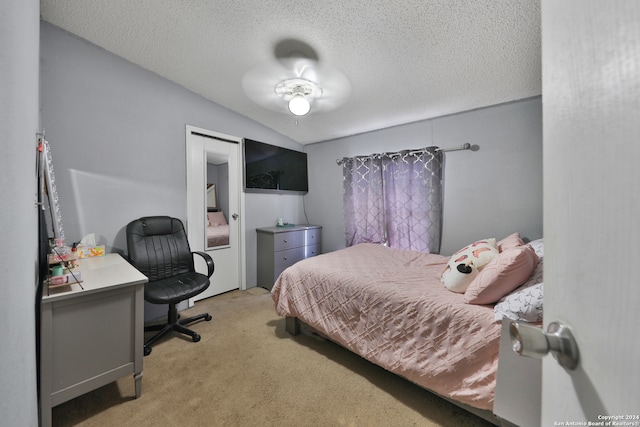 bedroom featuring a textured ceiling, light colored carpet, and vaulted ceiling