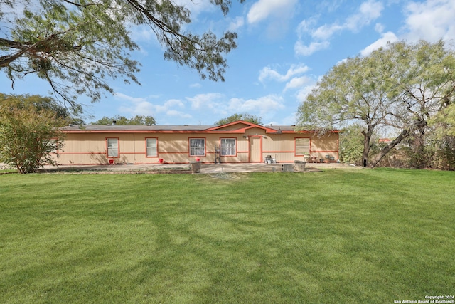 rear view of property with a patio and a lawn