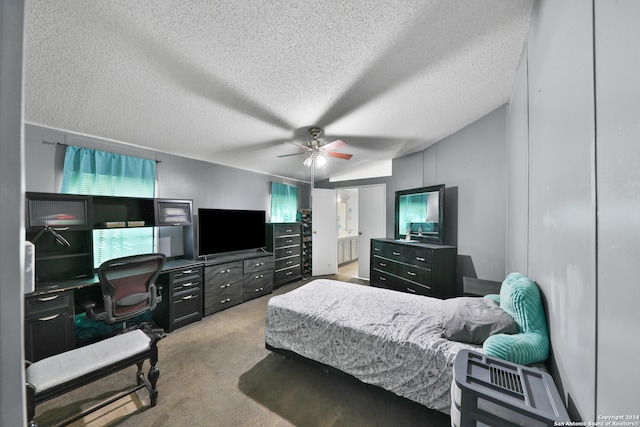 carpeted bedroom featuring multiple windows, a textured ceiling, ensuite bath, and ceiling fan