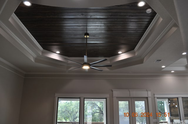 room details featuring a raised ceiling, crown molding, ceiling fan, and wooden ceiling