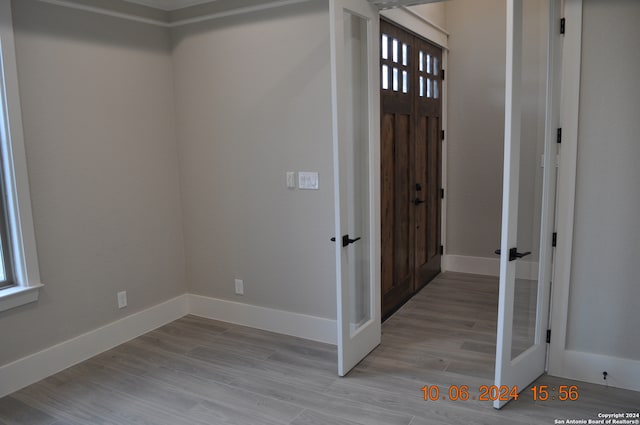 entryway with french doors and light hardwood / wood-style floors