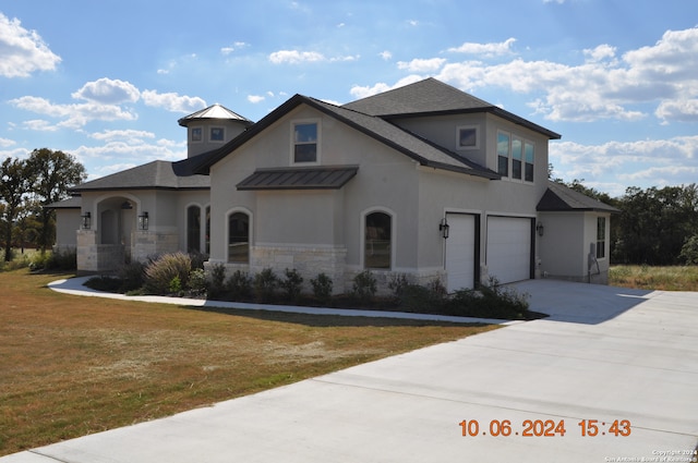 view of front of property featuring a garage and a front yard