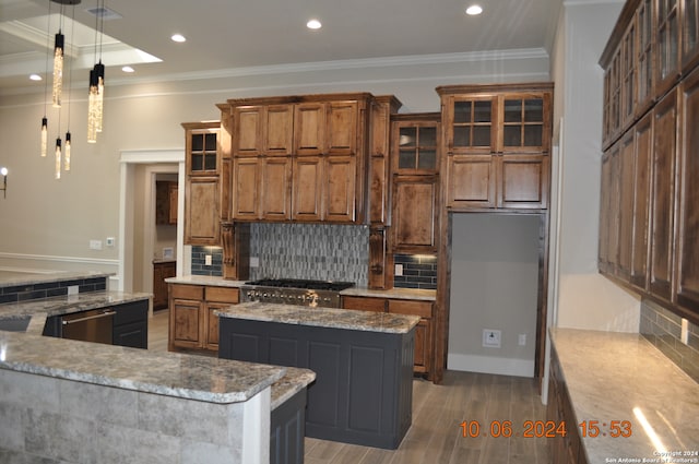 kitchen featuring hardwood / wood-style flooring, a kitchen island, ornamental molding, and backsplash