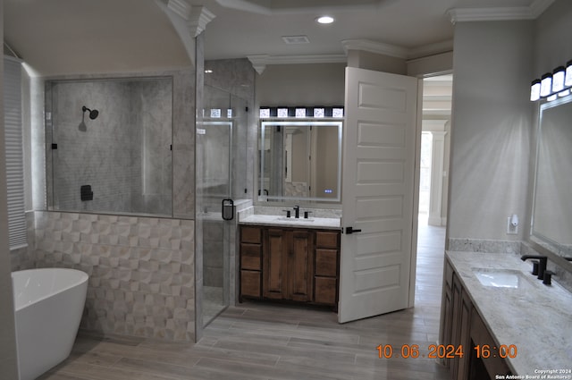 bathroom featuring hardwood / wood-style flooring, vanity, independent shower and bath, and ornamental molding