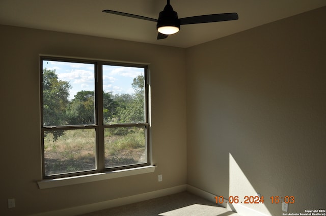 empty room featuring carpet flooring and ceiling fan