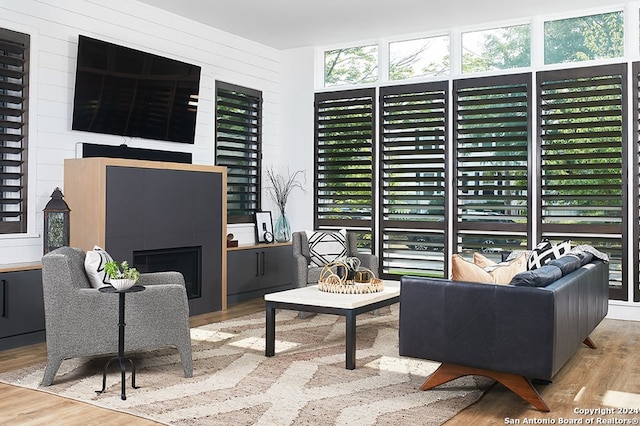 interior space with light hardwood / wood-style flooring and a tiled fireplace