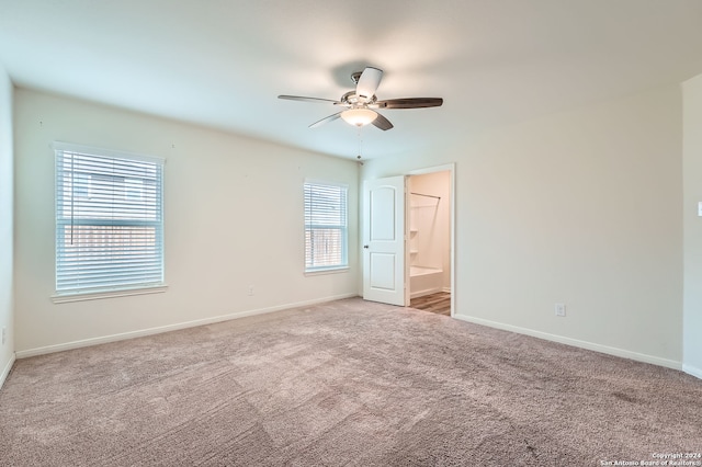 spare room featuring ceiling fan and carpet floors