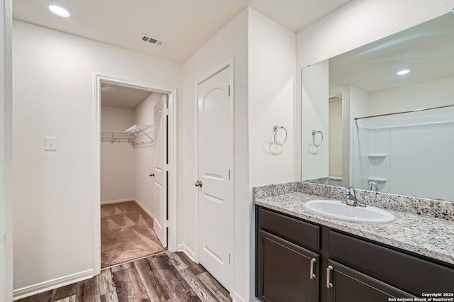 bathroom featuring hardwood / wood-style flooring and vanity