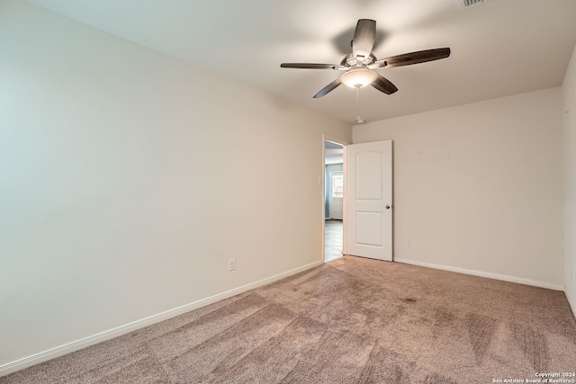 carpeted empty room featuring ceiling fan