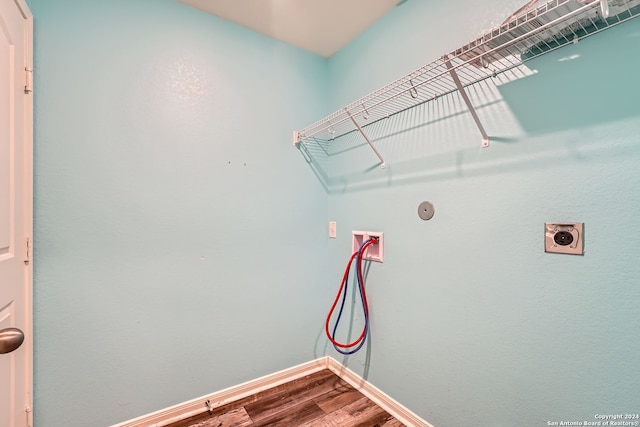 washroom with hookup for an electric dryer, hardwood / wood-style flooring, and washer hookup