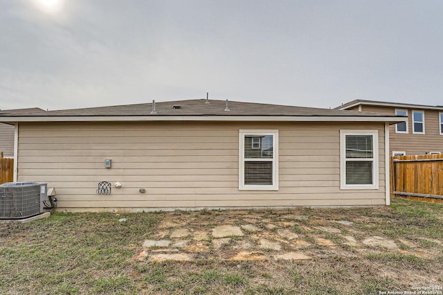 rear view of house featuring central air condition unit