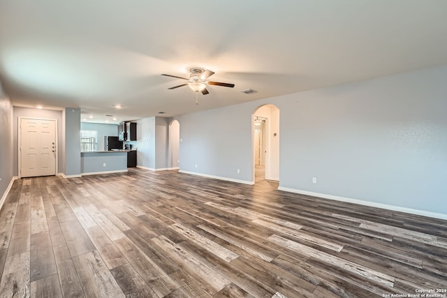 unfurnished living room featuring hardwood / wood-style floors and ceiling fan