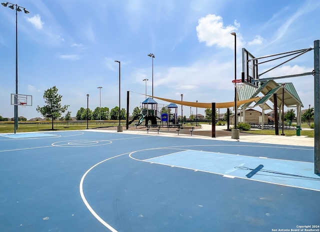 view of basketball court with a playground