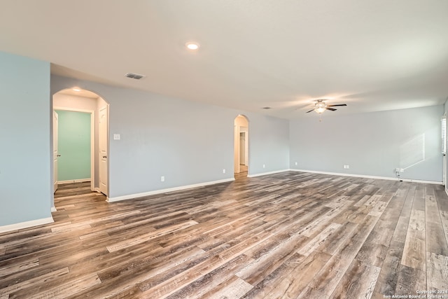 spare room with hardwood / wood-style flooring and ceiling fan