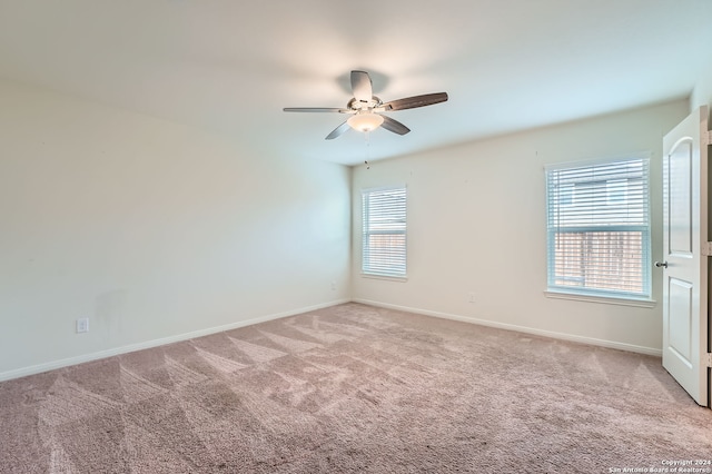 carpeted empty room featuring ceiling fan