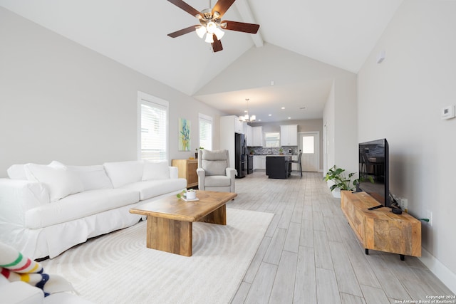 living room featuring ceiling fan with notable chandelier, beam ceiling, light wood-type flooring, and high vaulted ceiling