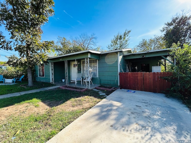 single story home with covered porch and a front lawn