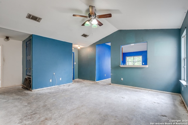 interior space featuring ceiling fan, concrete flooring, and vaulted ceiling