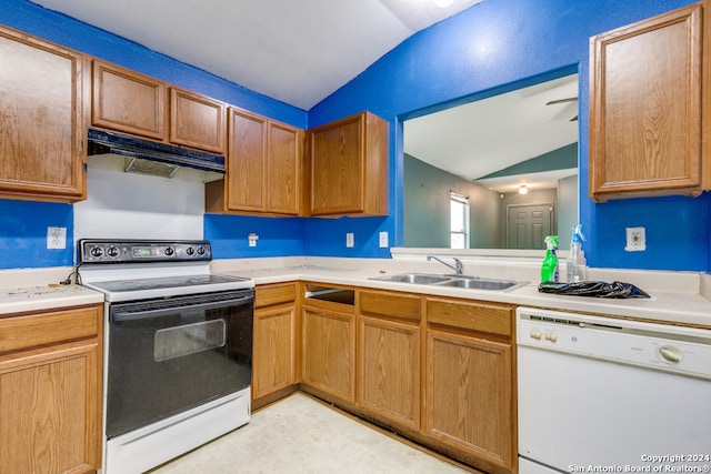 kitchen with lofted ceiling, white appliances, and sink