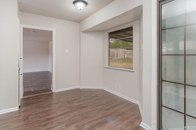 unfurnished room featuring dark hardwood / wood-style flooring