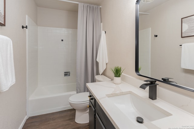 full bathroom featuring shower / bath combo with shower curtain, hardwood / wood-style floors, vanity, and toilet