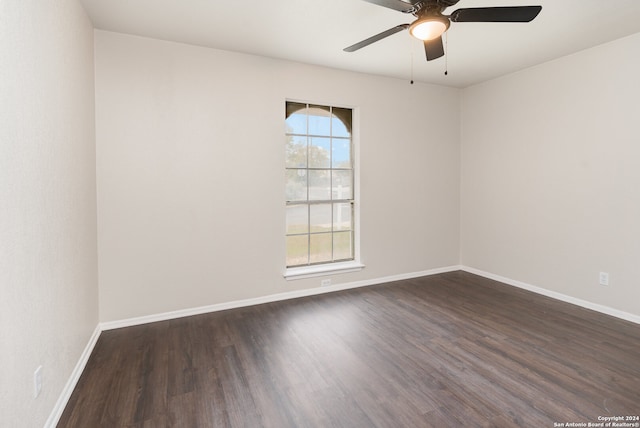 unfurnished room with ceiling fan and dark hardwood / wood-style floors