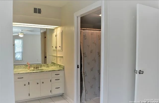 bathroom featuring ceiling fan, vanity, a shower with curtain, and tile patterned floors