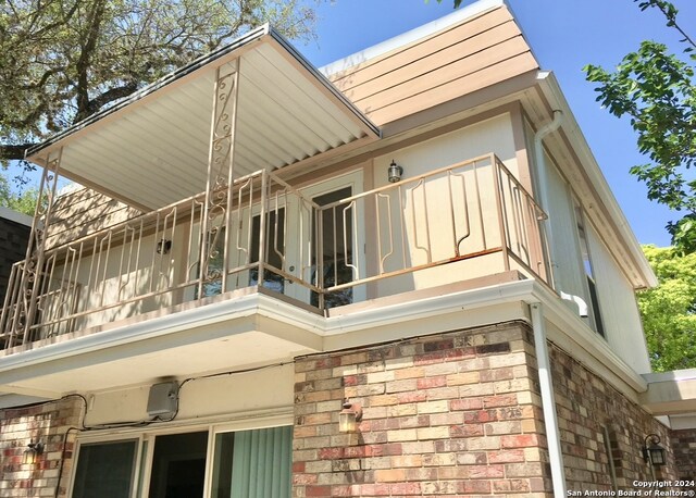 view of home's exterior with a balcony