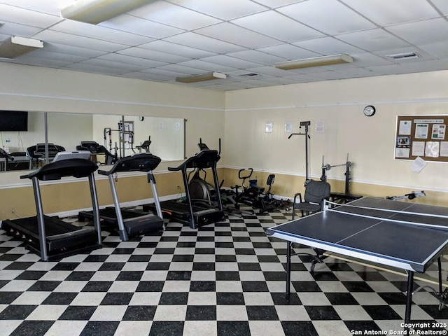 exercise room with a paneled ceiling