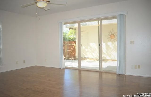 empty room with ceiling fan and hardwood / wood-style flooring