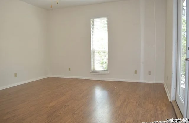 unfurnished room featuring hardwood / wood-style floors