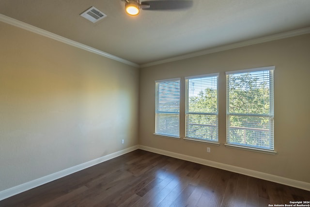 unfurnished room featuring ceiling fan, dark wood-type flooring, and ornamental molding